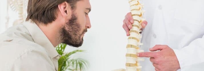 man looking at spinal column