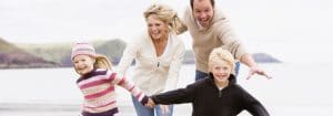 Family running on beach