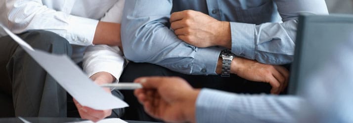 Men sitting, looking at paperwork